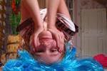Girl upside down with blue wig.